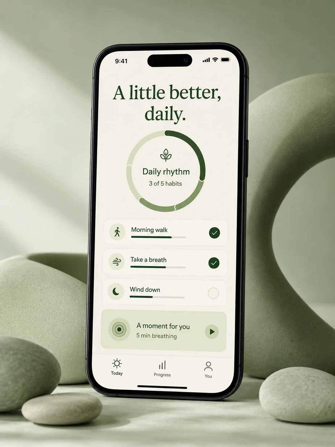 A wellness app with a daily activity ring, simple habits, and a breathing session on a phone among sage-green sculptural forms.